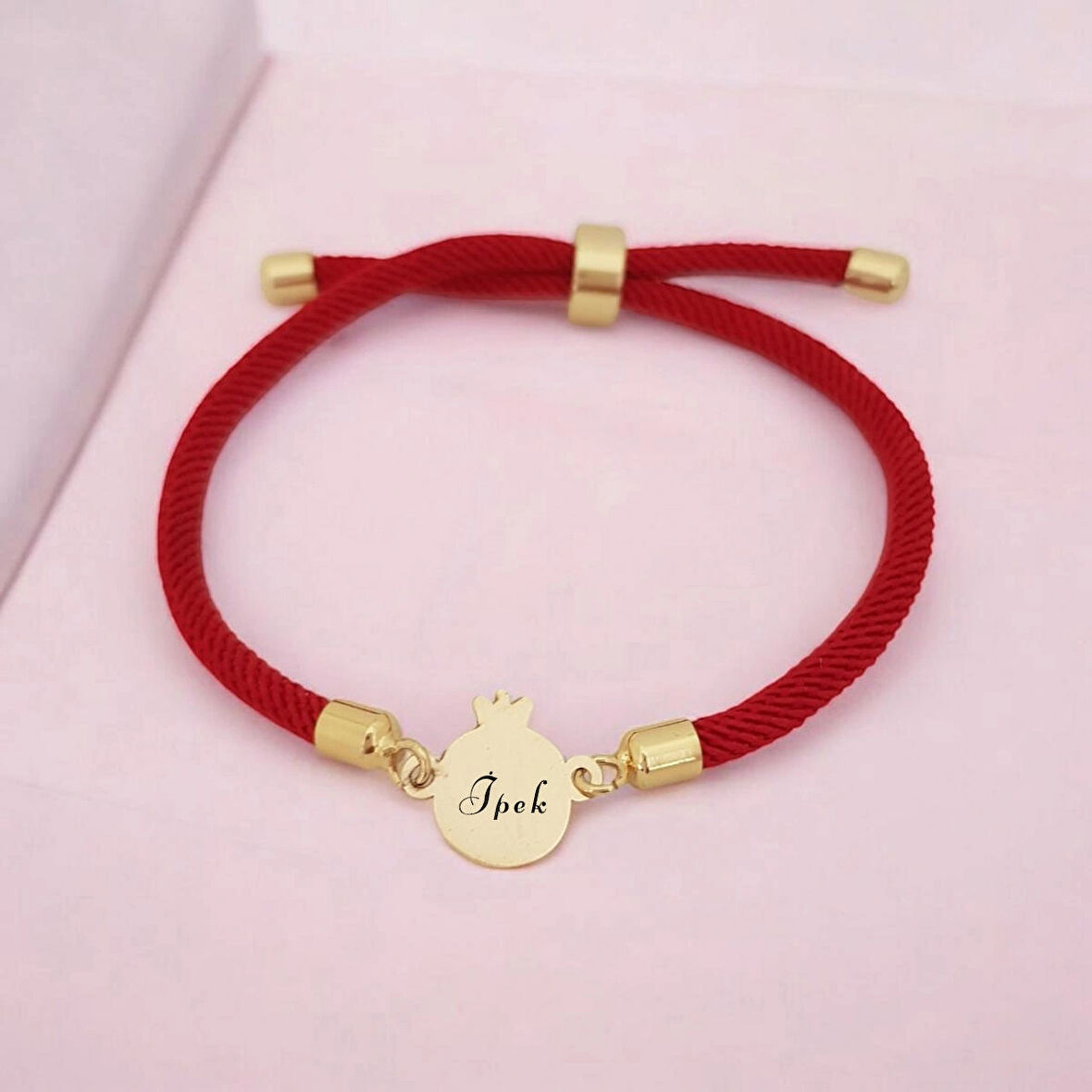 Nar Figürlü Örgü İpli Bayanlar İçin 14 Ayar Altın Plakalı İsme Özel Bileklik-323isim-kırmızı