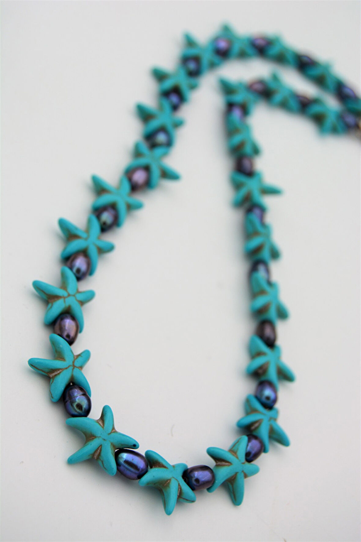 STONEAGE Siyah İnci ve Turkuaz Taşlı T Kilit Şifa Kolyesi Nazar İçin