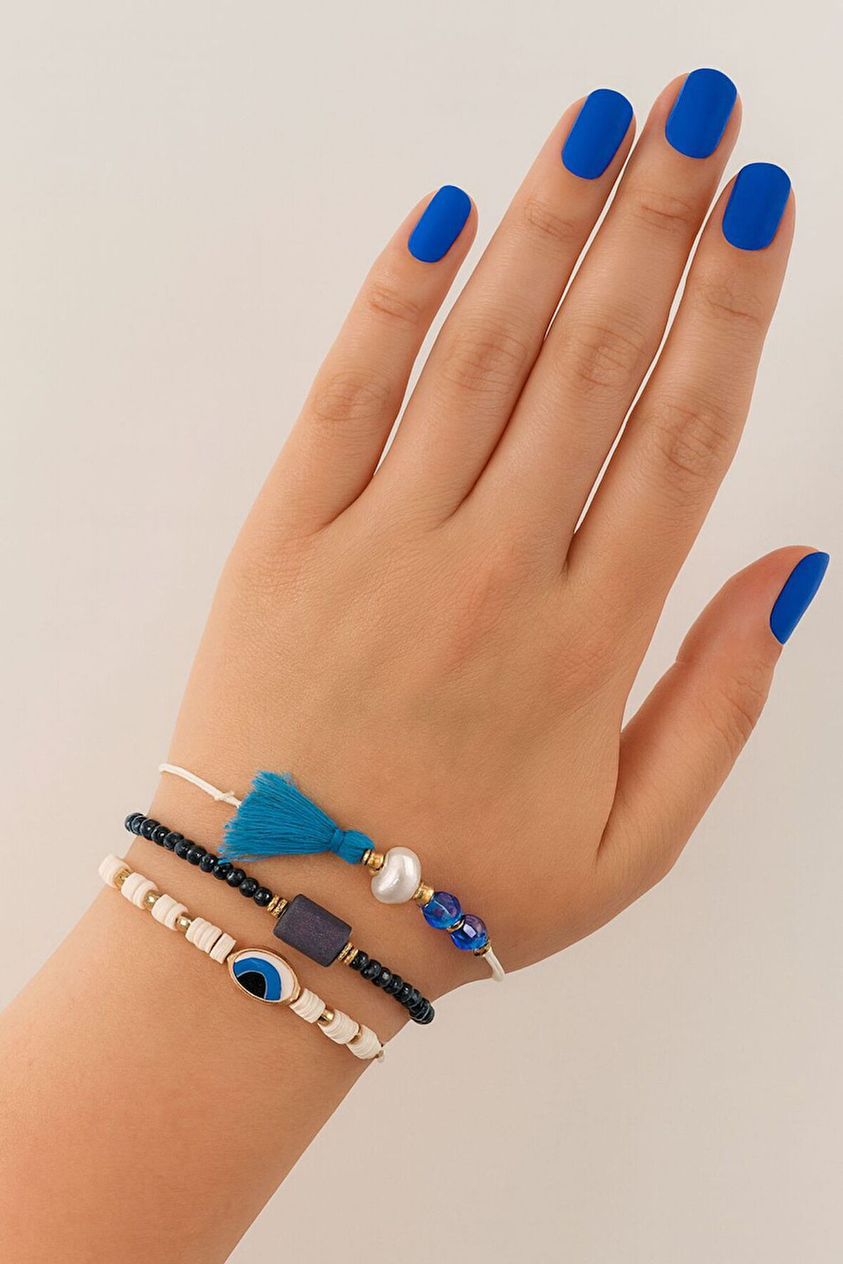 3lü püsküllü incili nazar boncuklu asansörlü bileklik. Lastikli boncuklu bileklik. Kadın ip bileklik