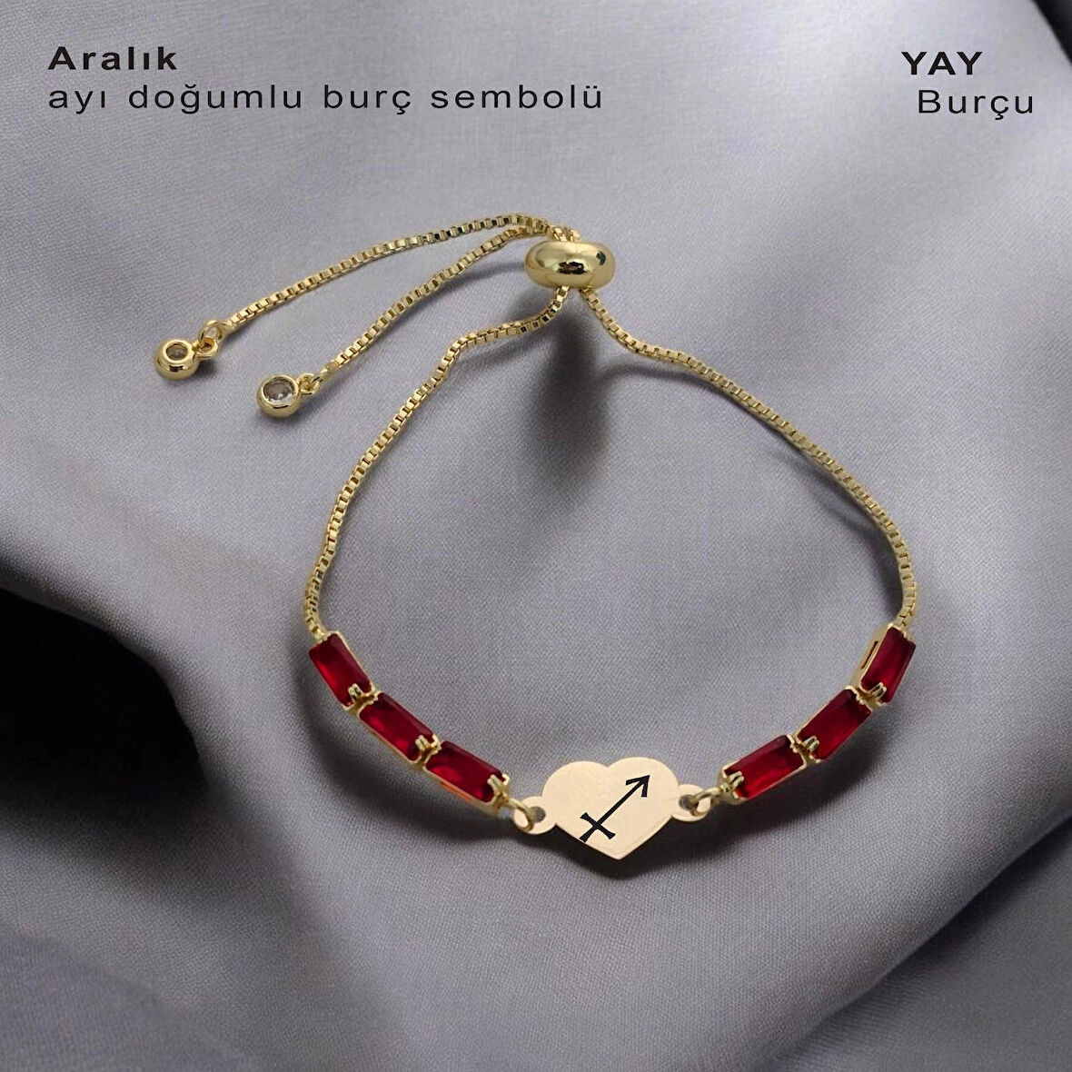 Yeni Yılın Umutlarını Taşıyan Kalp Motifli Kırmızı Taşlı 14 Ayar Altın Plakalı Aralık Bilekliği