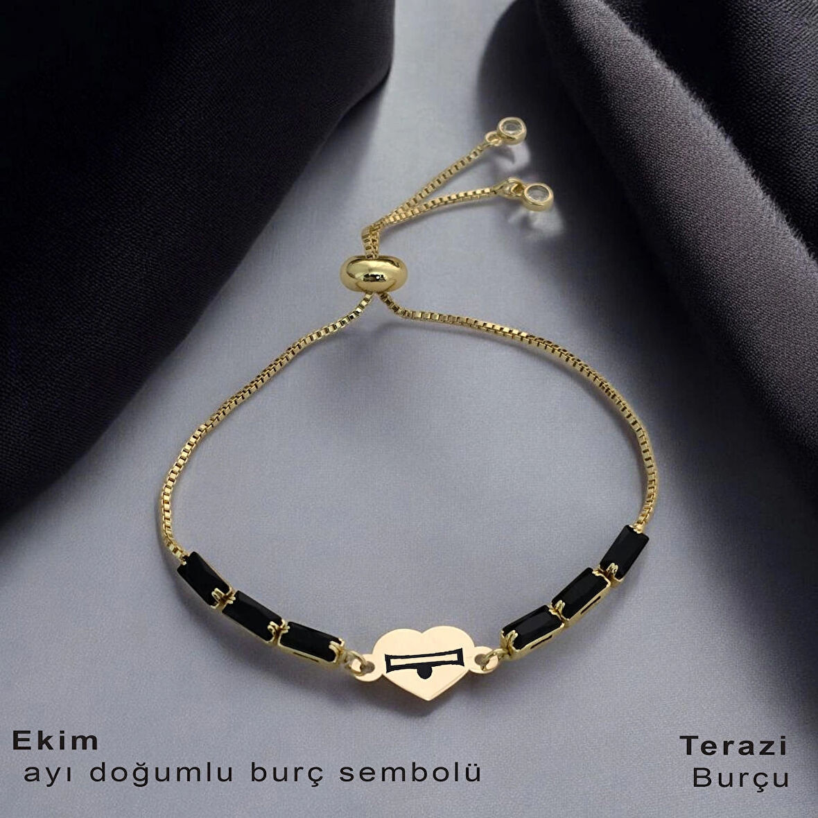 Yenilenmeyi Yansıtan Kalp Motifli ve Siyah Taşlı 14 Ayar Altın Plakalı Ekim Bilekliği