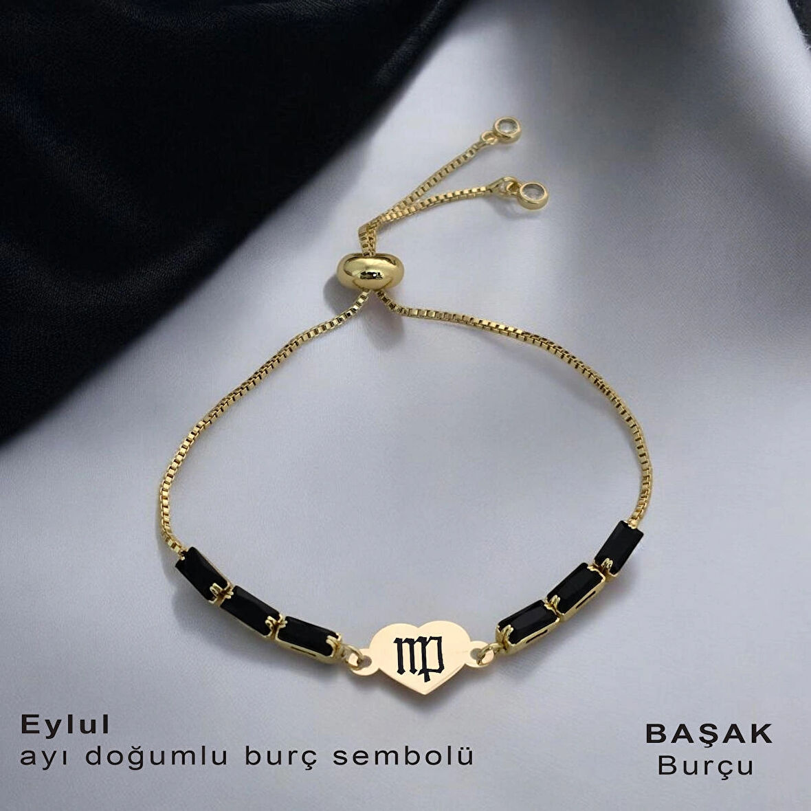 Sonbaharın Huzurunu Yansıtan Kalp Motifli ve Parlak Siyah Taşlı 14 Ayar Altın Plakalı Eylül Bilekliği