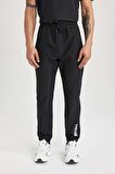 DeFactoFit Dokuma Esnek Multifonksiyonel Sporcu Jogger Eşofman Altı Slim Fit Dar Kesim Çift Cepli C1212AX24SPBK81