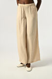 KADIN BELİ LASTİKLİ BOL PAÇA KIRIŞIK KUMAŞ DÜZ RENK PANTOLON