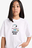 DeFacto Kız Çocuk Snoopy Oversize Geniş Kalıp Bisiklet Yaka Sırt Baskılı Kısa Kollu Tişört E6551A825HSWT34