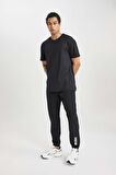 DeFactoFit Dokuma Esnek Multifonksiyonel Sporcu Jogger Eşofman Altı Slim Fit Dar Kesim Çift Cepli C1212AX24SPBK81