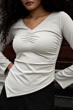 Kadın Likralı Esnek Hafif Parlak Kumaş V Yaka Büzgülü Uzun Kol Asimetrik Bluz-Taş