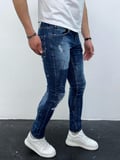 Erkek Mavi Slim Fit Yıpratılmış ve Boya Detaylı Denim Pantolon – Modern Sokak Stili, Rahat Kesim