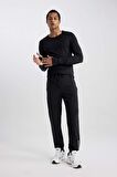 DeFactoFit Dokuma Esnek Multifonksiyonel Sporcu Jogger Eşofman Altı Slim Fit Dar Kesim Çift Cepli C1212AX23WNBK81