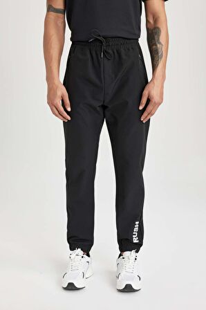 DeFactoFit Dokuma Esnek Multifonksiyonel Sporcu Jogger Eşofman Altı Slim Fit Dar Kesim Çift Cepli C1212AX24SPBK81