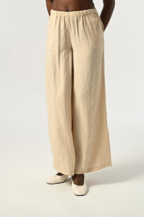 KADIN BELİ LASTİKLİ BOL PAÇA KIRIŞIK KUMAŞ DÜZ RENK PANTOLON