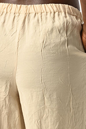 KADIN BELİ LASTİKLİ BOL PAÇA KIRIŞIK KUMAŞ DÜZ RENK PANTOLON