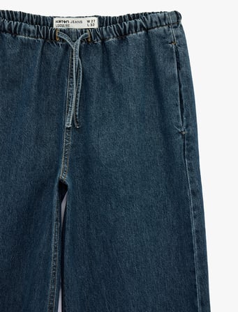 Beli Bağcıklı Cep Detaylı Bol Paça Denim Pantolon