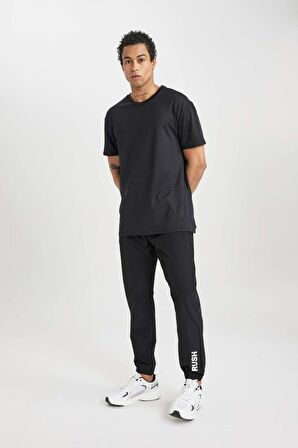 DeFactoFit Dokuma Esnek Multifonksiyonel Sporcu Jogger Eşofman Altı Slim Fit Dar Kesim Çift Cepli C1212AX24SPBK81