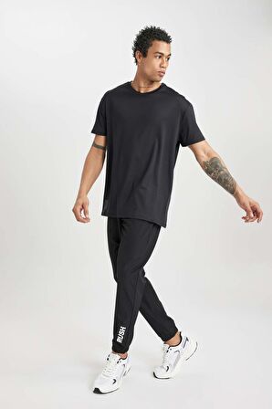 DeFactoFit Dokuma Esnek Multifonksiyonel Sporcu Jogger Eşofman Altı Slim Fit Dar Kesim Çift Cepli C1212AX24SPBK81